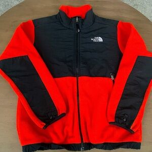 The North Face orange sweater.